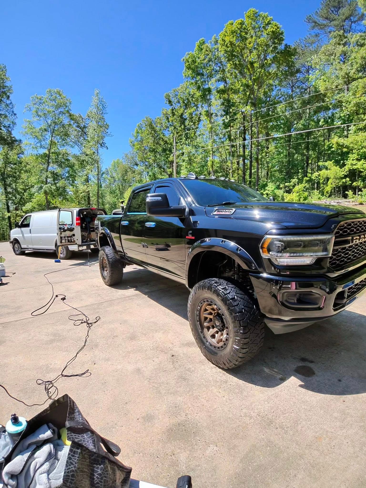 LuxeRide mobile detailing setup working on a lifted Ram truck in a customer driveway in Overland Park