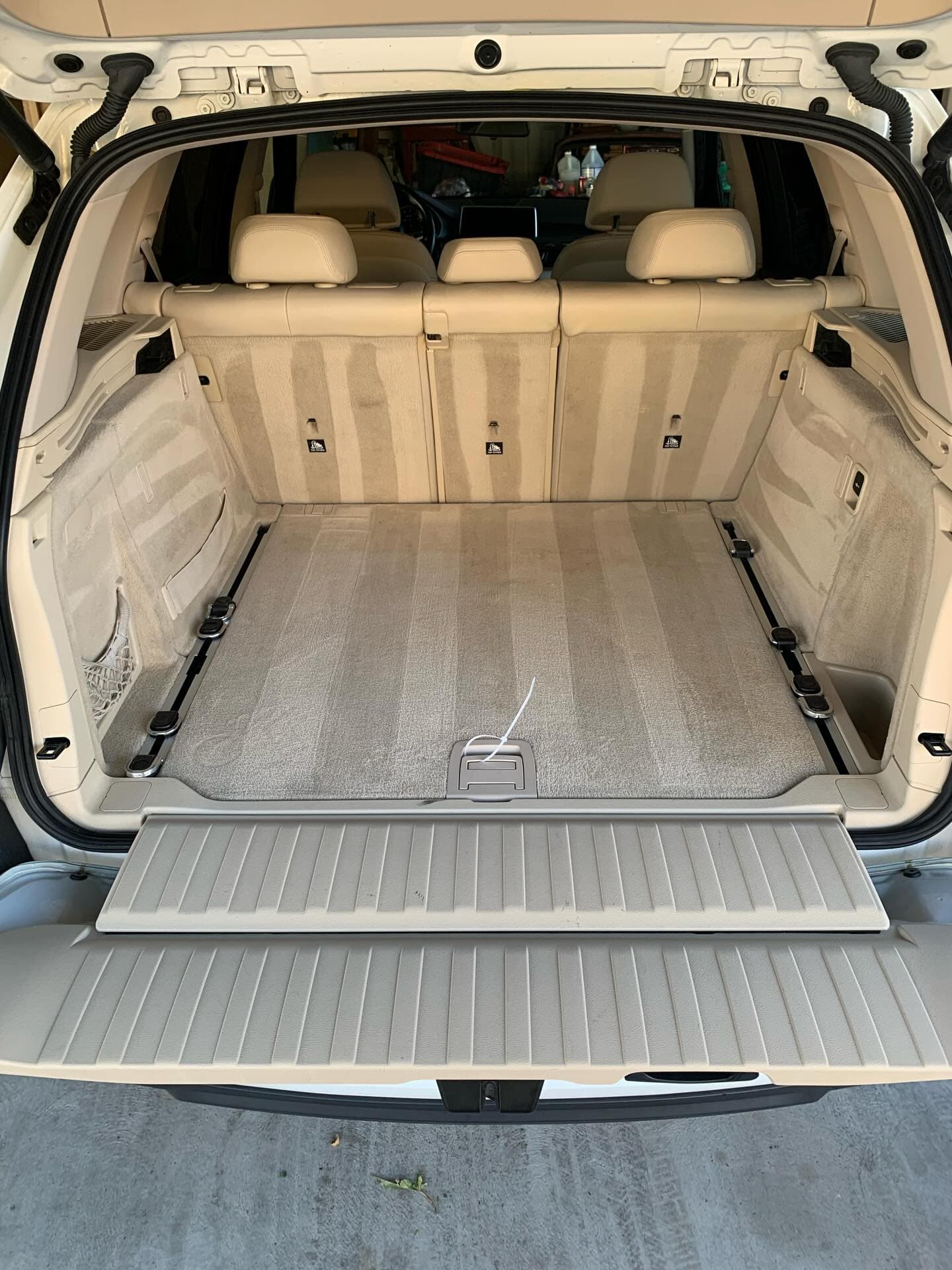BMW X5 trunk carpet after professional extraction cleaning with fresh lines