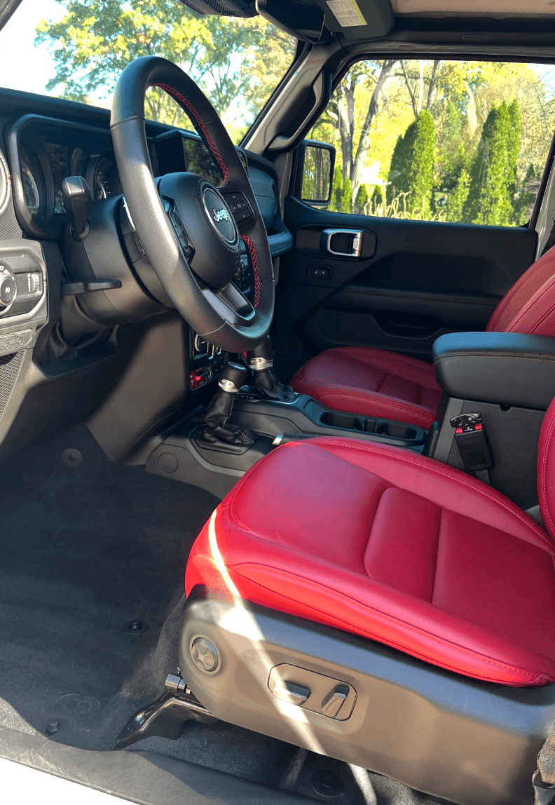 Jeep Wrangler Rubicon interior after detail showing clean red leather seats