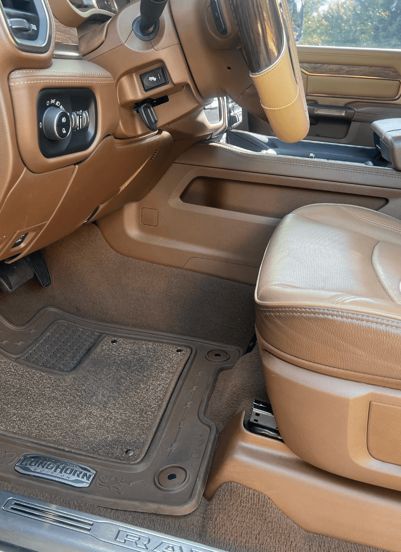 Ram 3500 interior after detail showing clean tan leather seats and fresh carpet