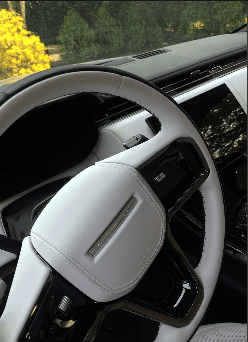 Range Rover Sport interior after detail showing clean steering wheel and dashboard