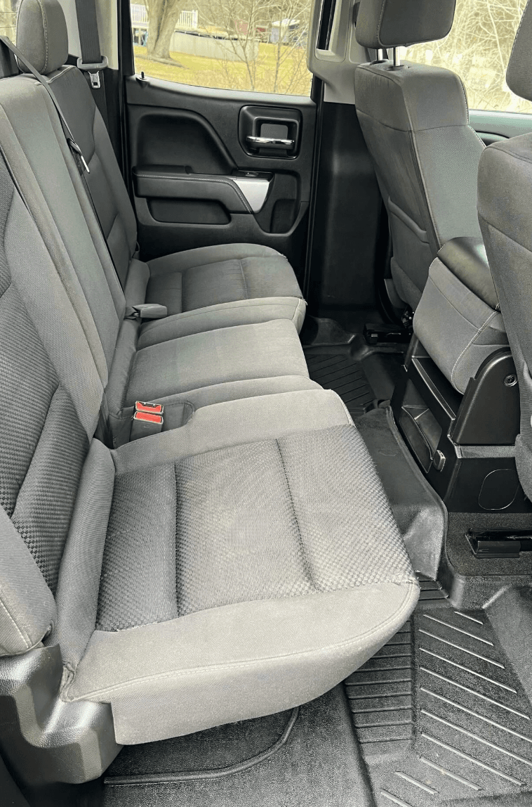 Chevy Silverado rear seat after professional interior detailing with clean cloth and carpet